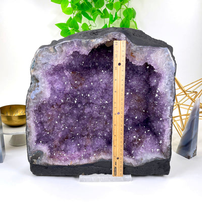 front of amethyst cave geode with vertical ruler for height