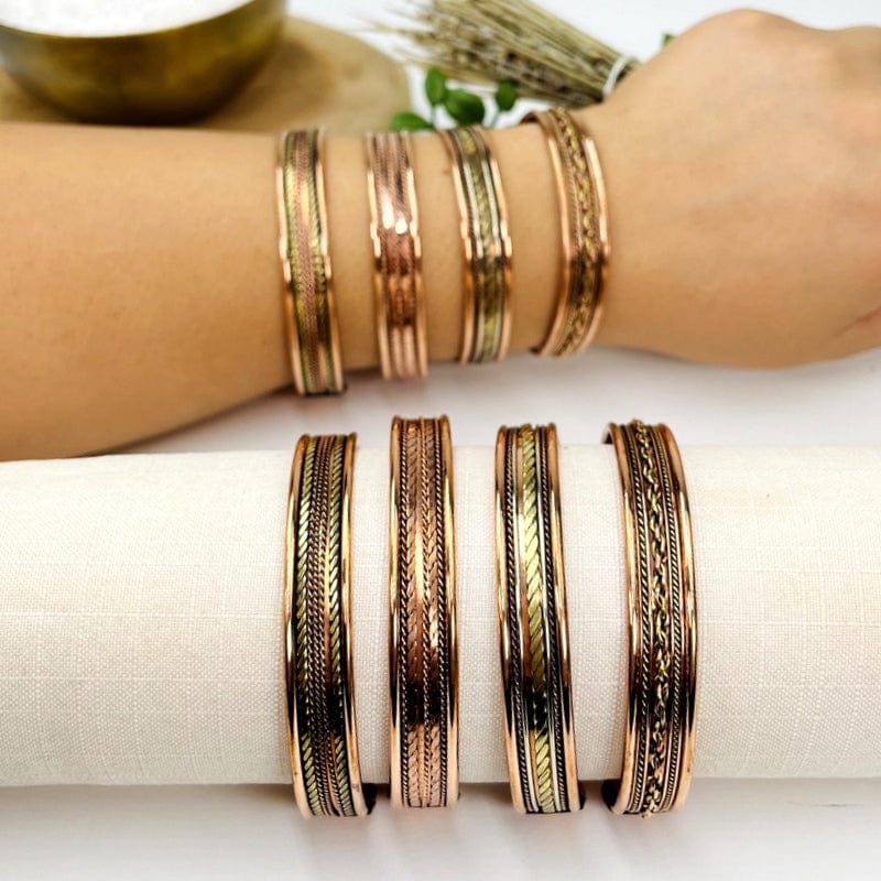 set of four copper bracelets displayed on wrist to show that they are adjustable 