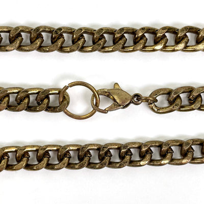 close up of gold chain and necklace clasp on white background for details