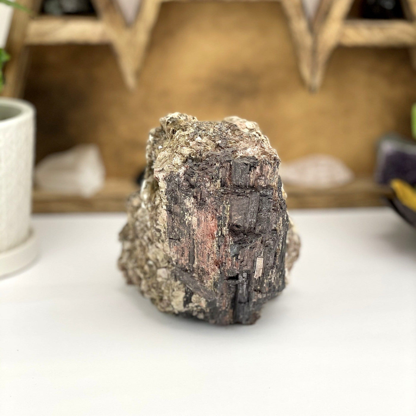 Black Tourmaline with decorations in the background