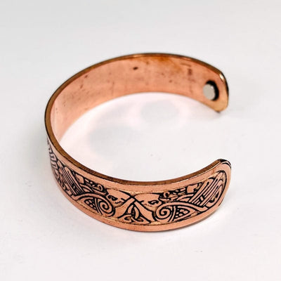 side view of the copper bracelet to show the engraved design