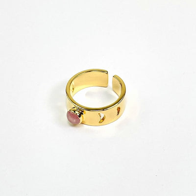 close up of gold moon phase adjustable ring with rose quartz center accent on white background 