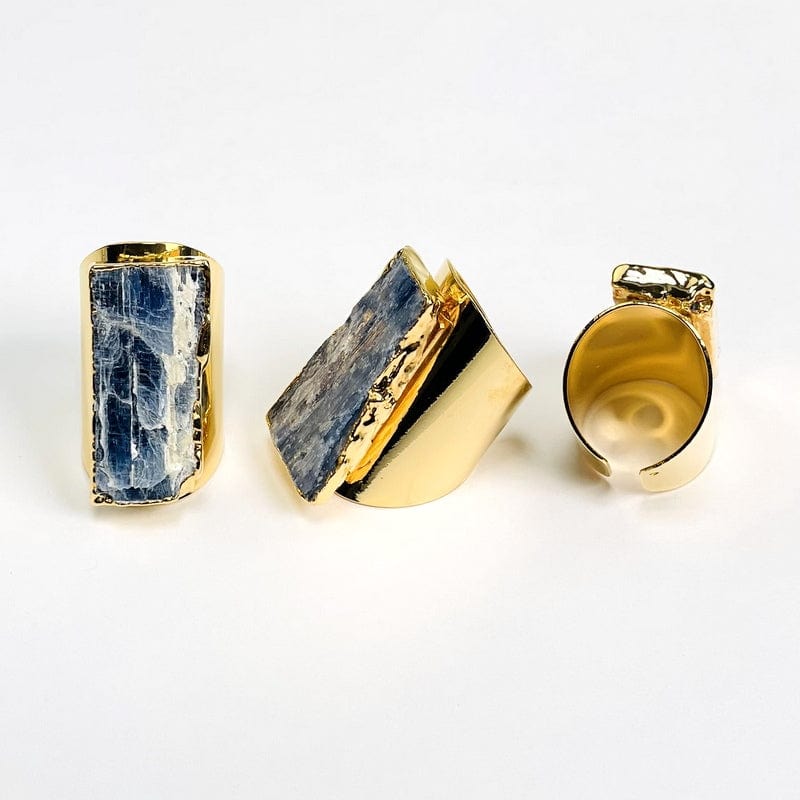 multiple angles of blue kyanite gold cigar band adjustable rings