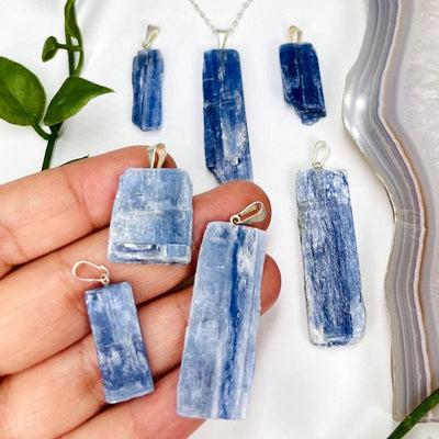 blue kyanite pendants with silver bail in hand for size reference 