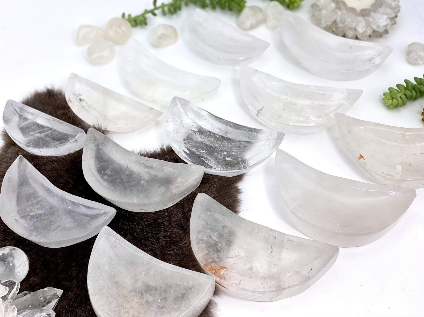 side view of crystal quartz moon bowls for thickness reference on white background