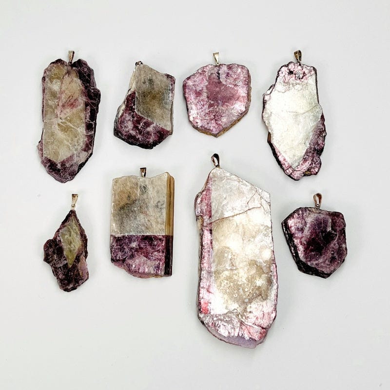 multiple mica slice pendants displayed next to each other to show the differences in the sizes 