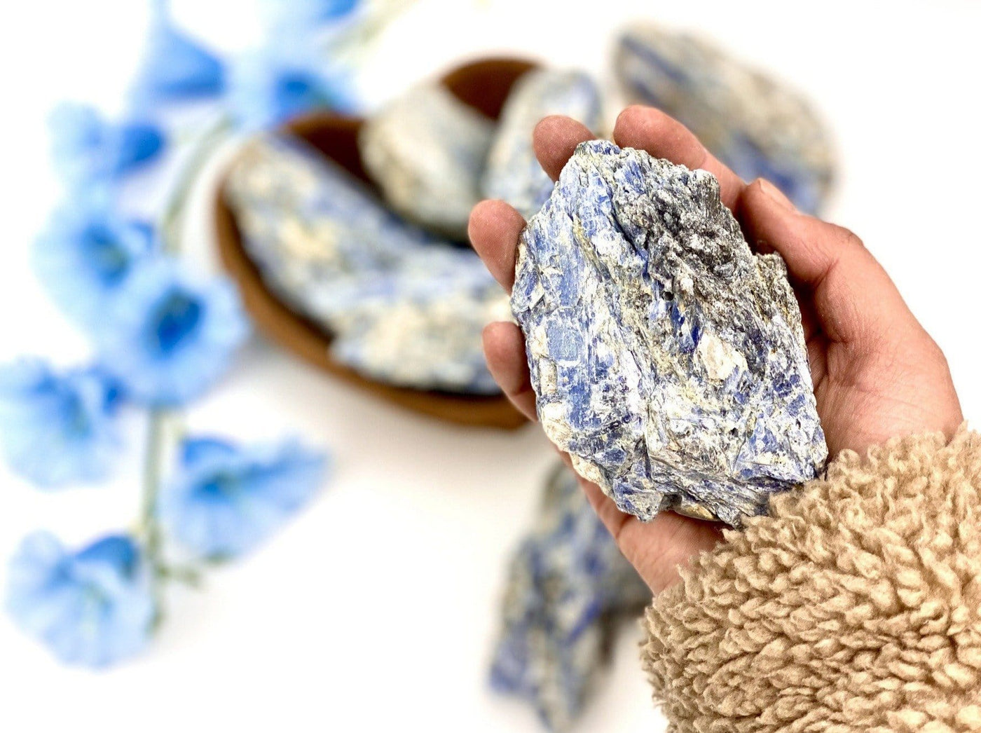 natural blue kyanite cluster in hand for size reference 