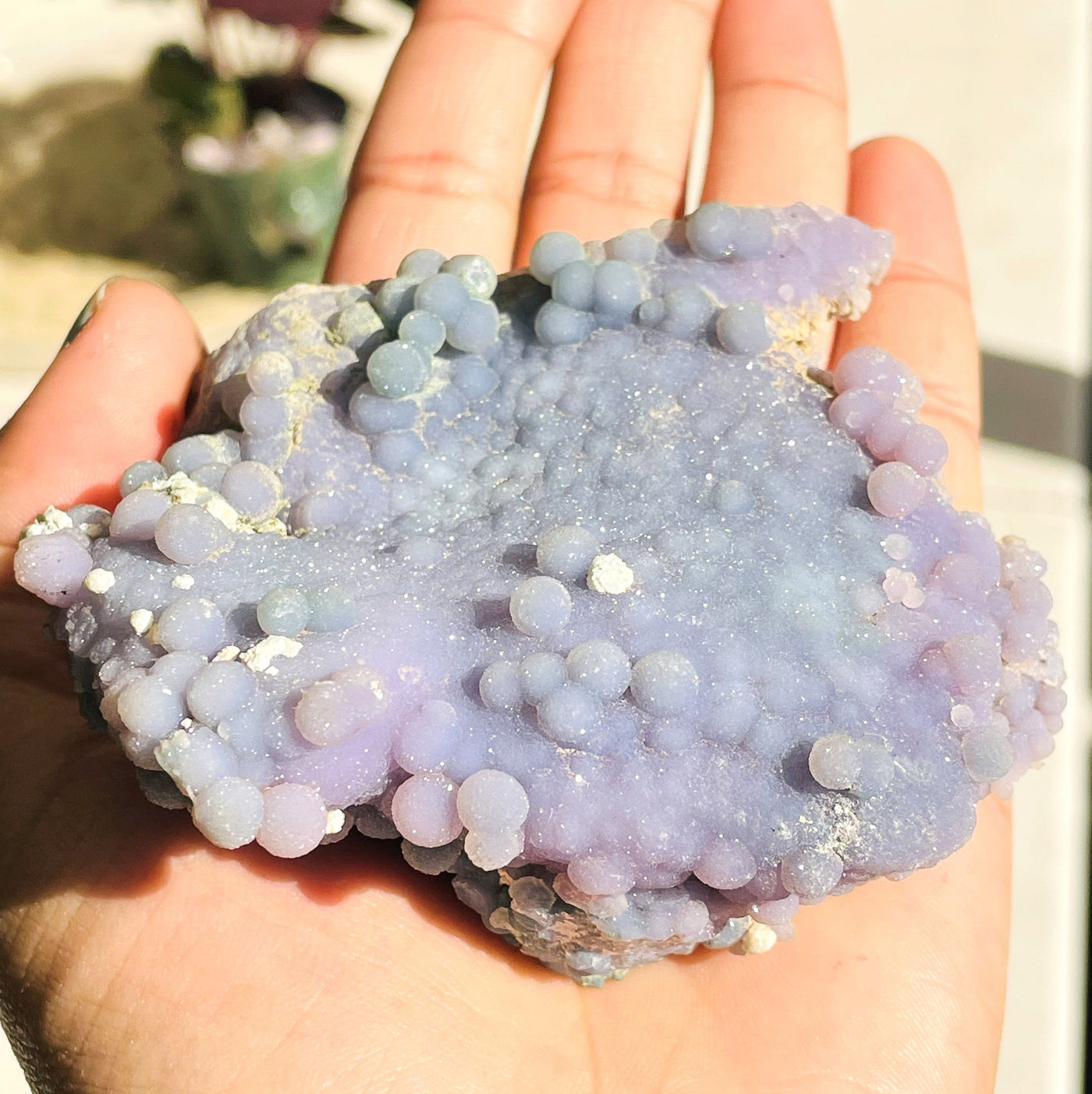 hand holding up Grape Agate Cluster