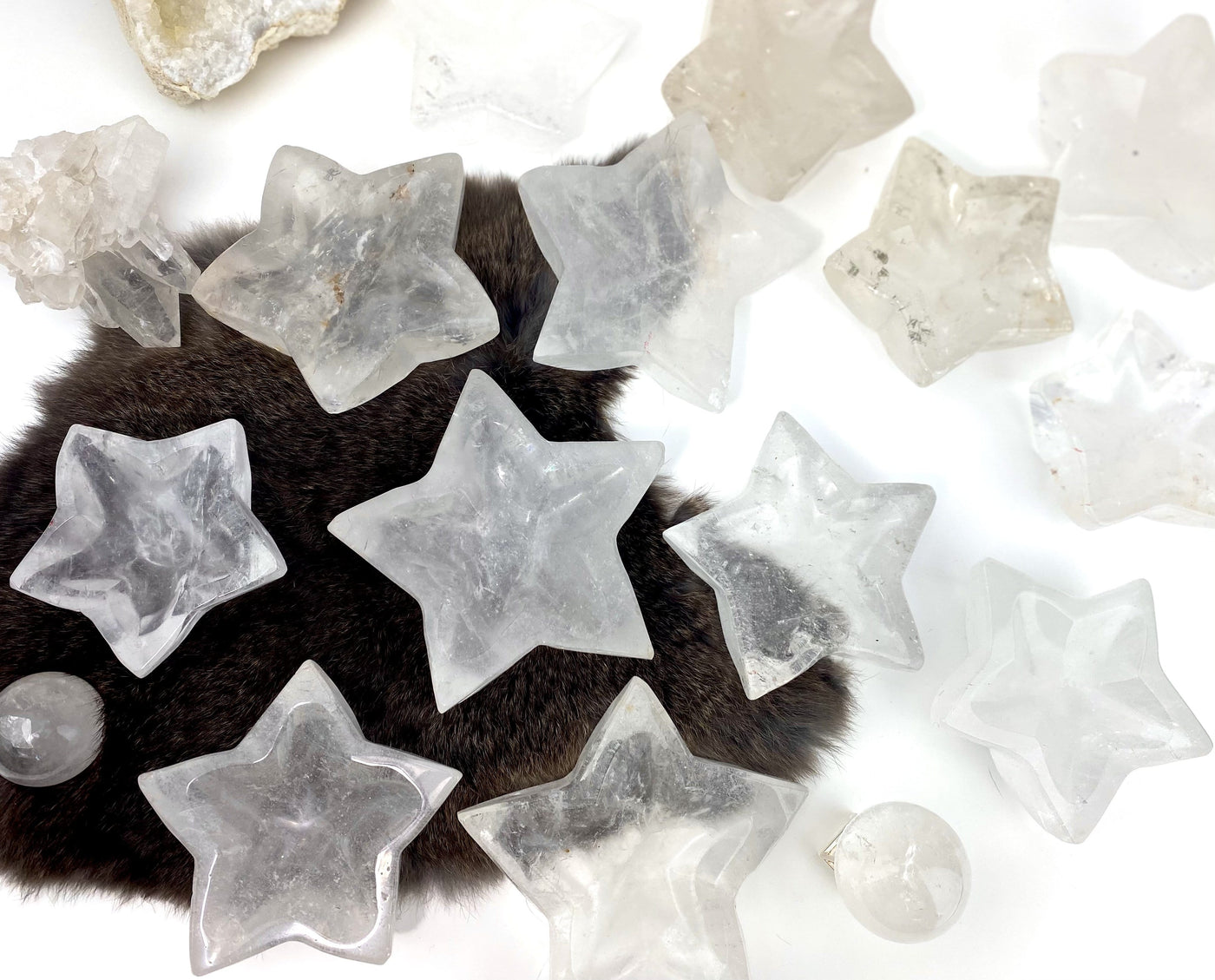 multiple crystal quartz star dishes with decorations on white background