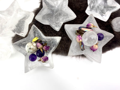 top view of crystal quartz star dishes with crystals inside them with more in the  background