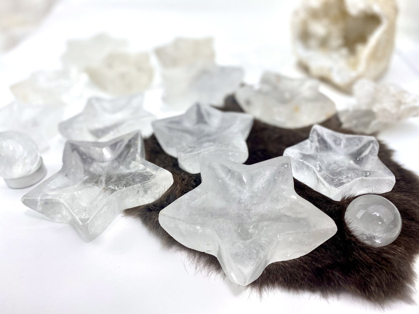 angled shot of crystal quartz star dishes with decorations in the background