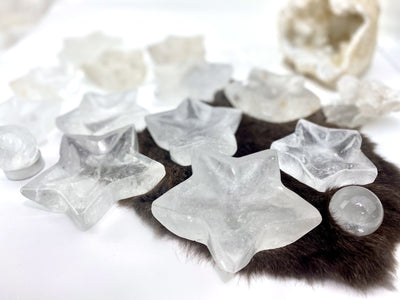 angled shot of crystal quartz star dishes with decorations in the background