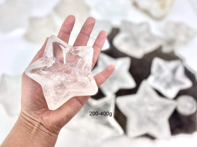 hand holding up 200-400g crystal quartz star dish