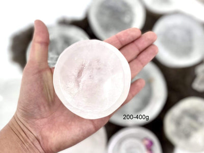 hand holding up 200-400g crystal quartz round dish