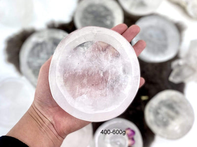 hand holding up 400-600g crystal quartz round dish