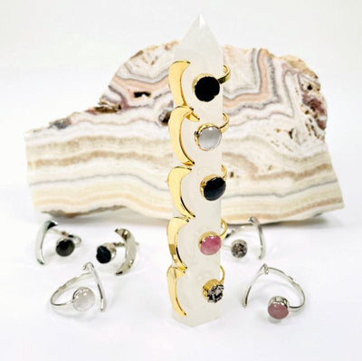 close up of silver and gold moon rings with gemstone accent