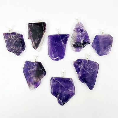 amethyst slab pendants with silver bail on a white background 