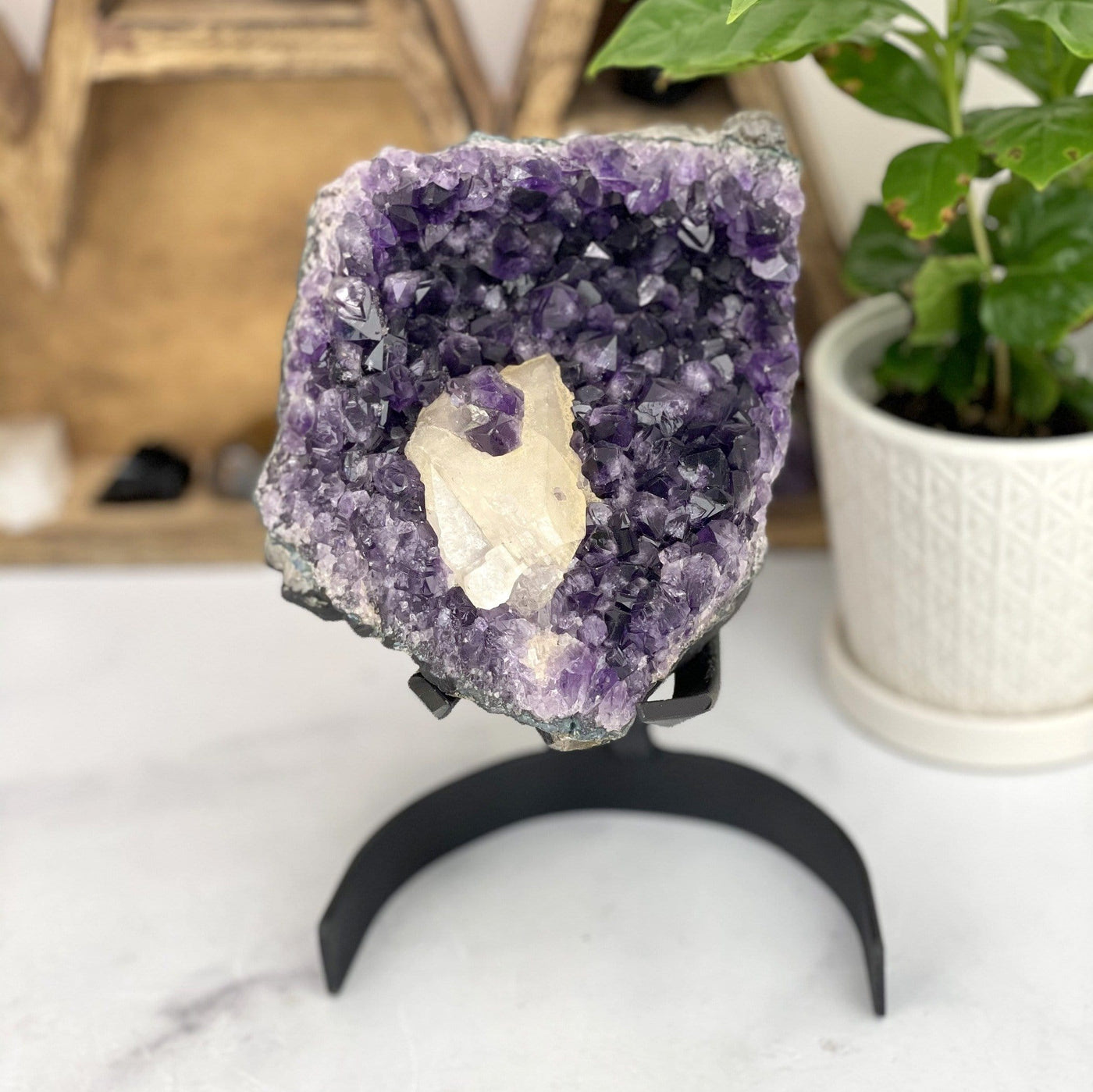Amethyst Crystal Cluster with Calcite with decorations in the background