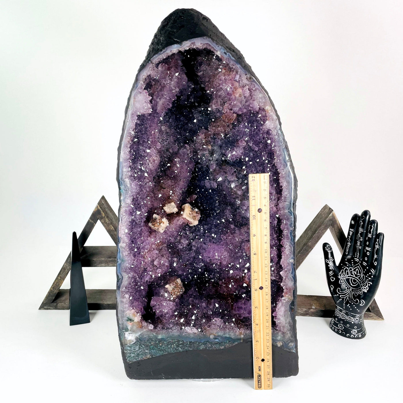 front of amethyst cave geode with vertical ruler for height reference