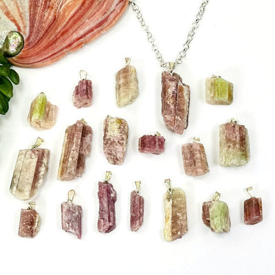 Raw Pink/Green Tourmaline Pendant with Silver Toned Bail on white background 