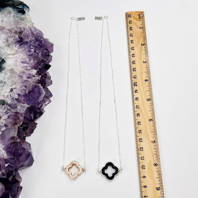 necklaces next to a ruler for size reference 