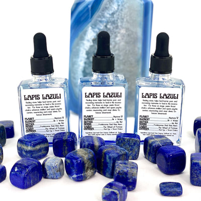 3 Lapis Lazuli Gem Essence Bottles displayed with cubes of lapis lazuli  on white background not included