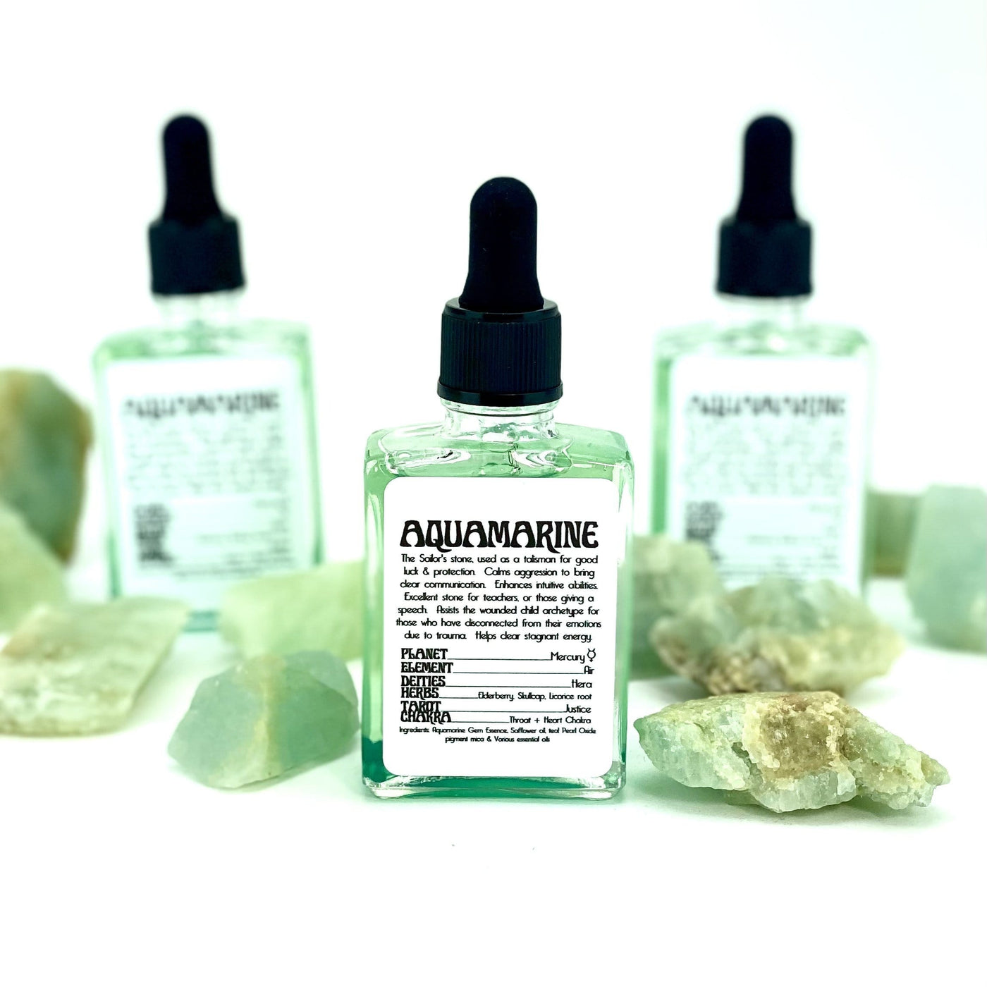 up close of the Aquamarine Gem Essence bottle showing details in the label and showing green hue liquid