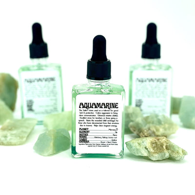 up close of the Aquamarine Gem Essence bottle showing details in the label and showing green hue liquid