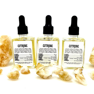 3 bottles of Citrine Gem Essence surrounded by citrine