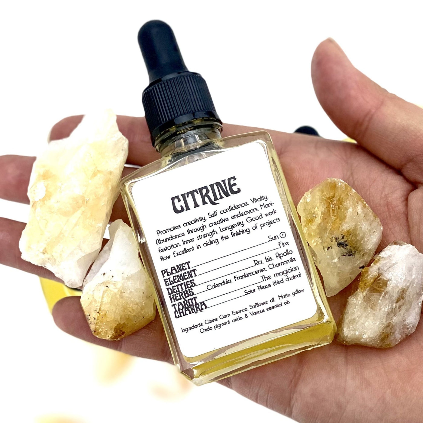 hand holding up Citrine Gem Essence with citrine crystals