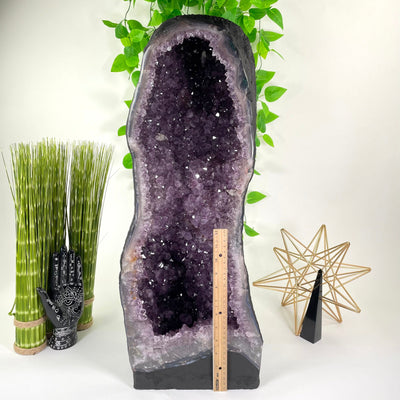 front of amethyst cave geode with vertical ruler for height reference