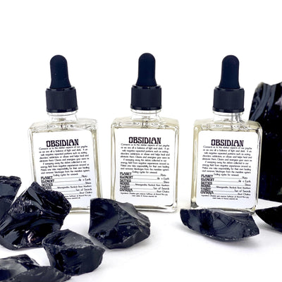 multiple Black Obsidian Gem Essence bottles displayed with obsidian chunks on white background not included