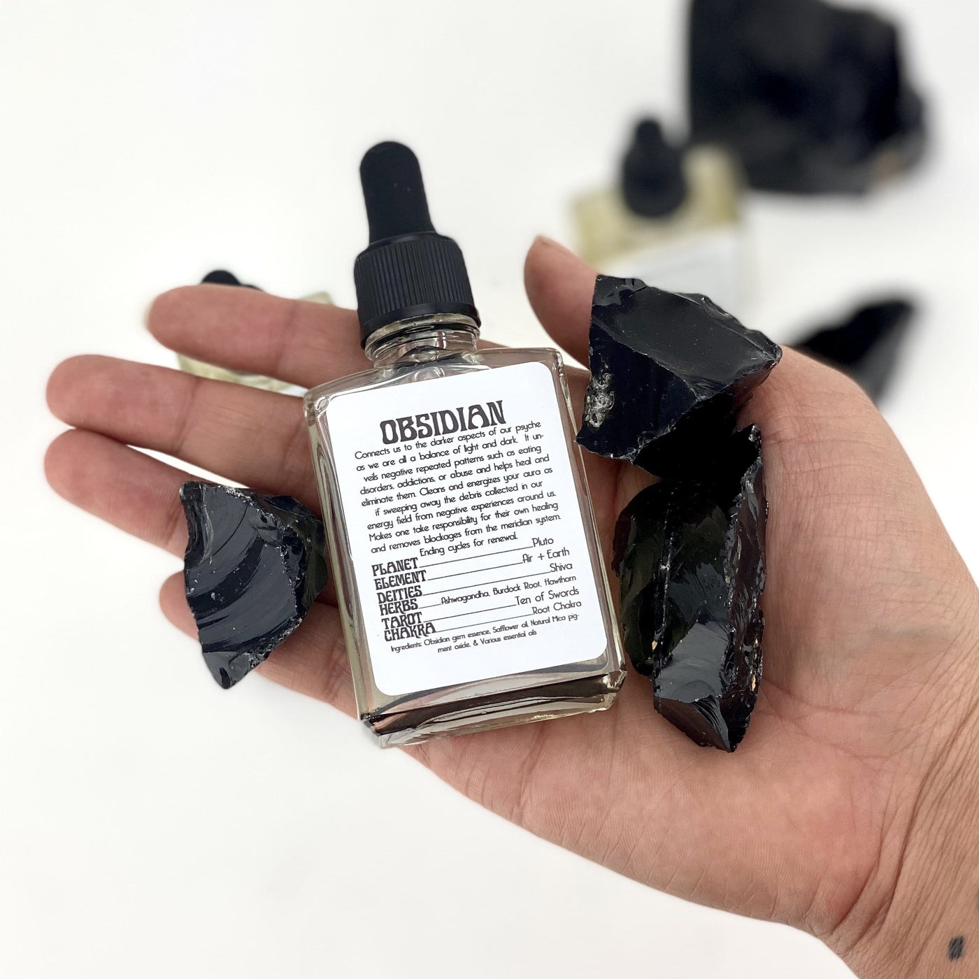 Black Obsidian Gem Essence Bottle in hand for size reference