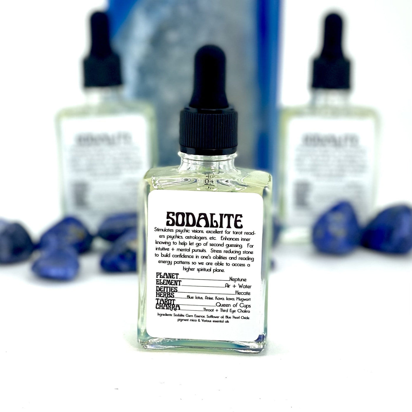 close up of the front of one sodalite gem essence bottle with two others in background display