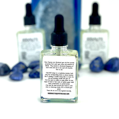 close up of the back of one sodalite gem essence bottle with two others in background display