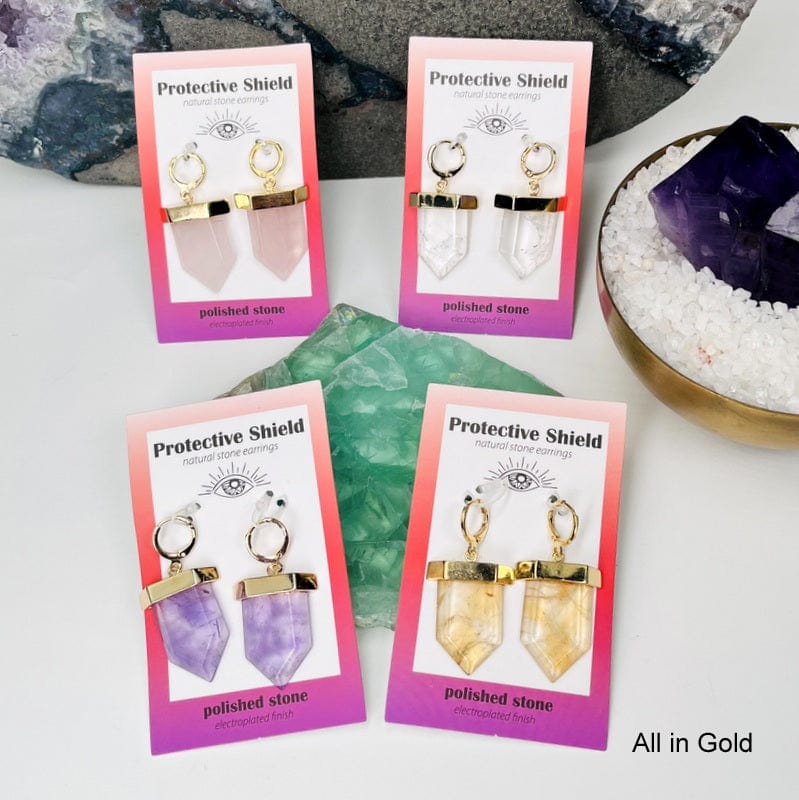 all of the crystal earrings electroplated in gold displayed to show the differences in the stones