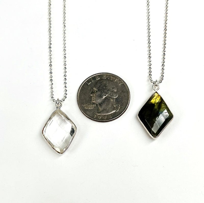 pendants next to a quarter for size reference 