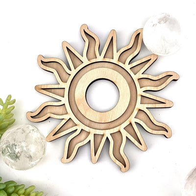 Wooden sun sphere holder on a white background.