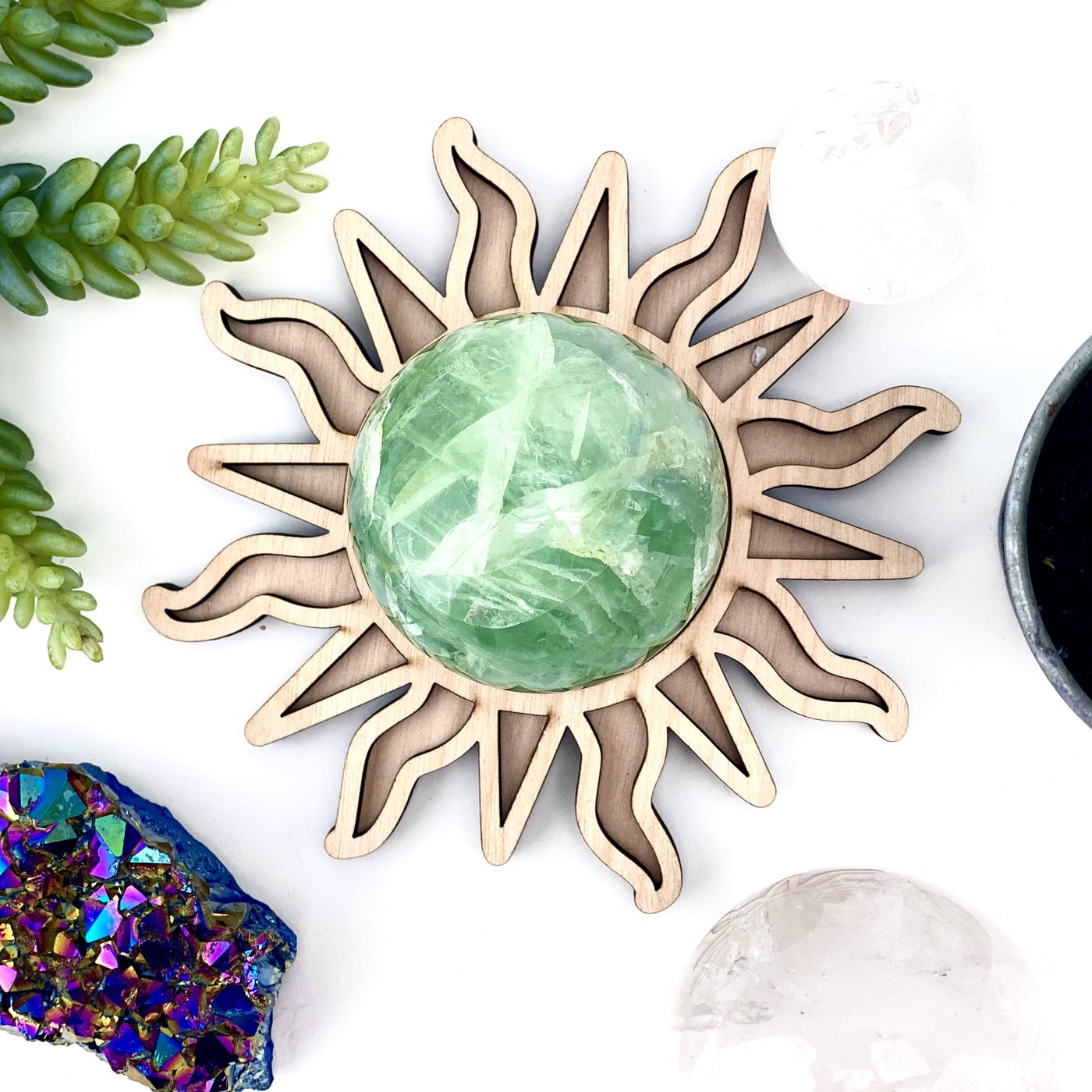 Wooden sun shaped sphere holder with a green fluorite sphere on it as an example of how it can be used.
