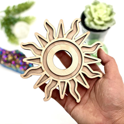 Wooden sun sphere holder in a hand.