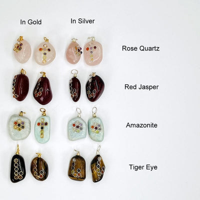 tumbled stones with a chakra accent displayed to show the available stones. all come with either a silver or gold bail. available in rose quartz, red jasper, amazonite and tiger eye. 