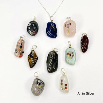 all of the tumbled stone pendants with a chakra accent and a silver toned bail 