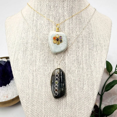 chakra pendants displayed on necklace 