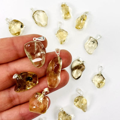 Natural Citrine Tumbled Stone with a Silver Bail - 4 on finger tips