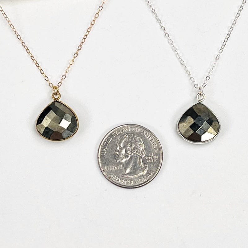 necklace pendants next to a quarter for size reference 