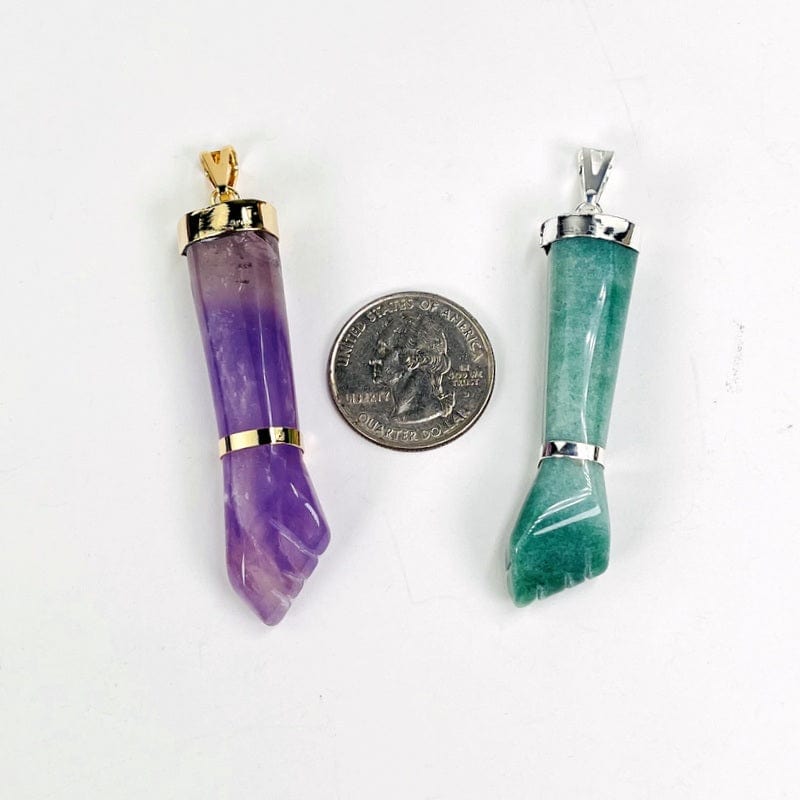close up of the pendants next to a quarter for size reference 