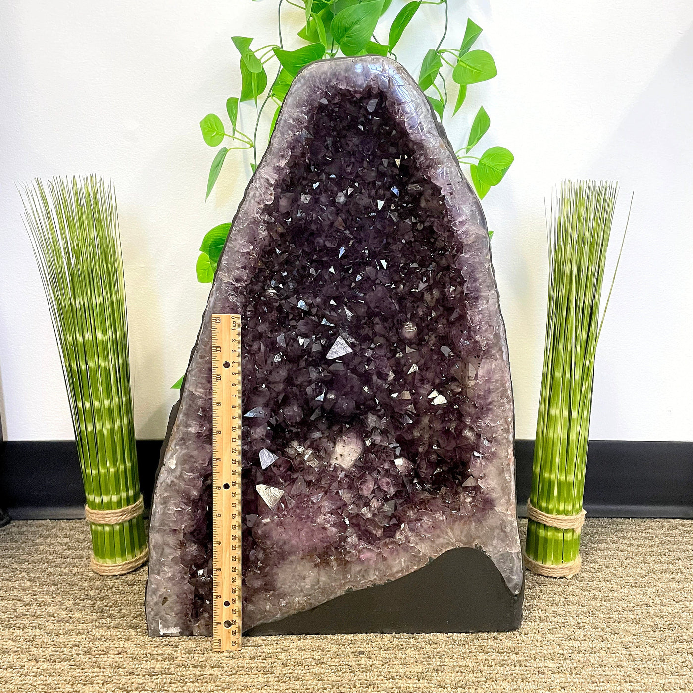 front of amethyst cave geode with vertical ruler for height reference