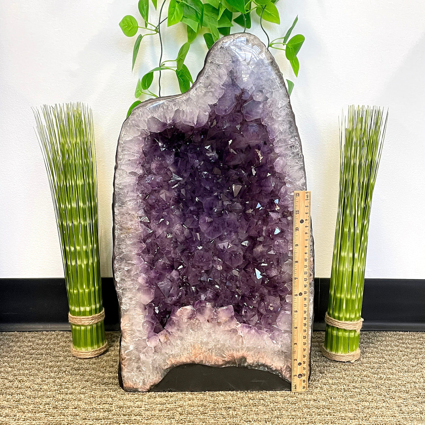 front of amethyst cave geode with vertical ruler for height reference
