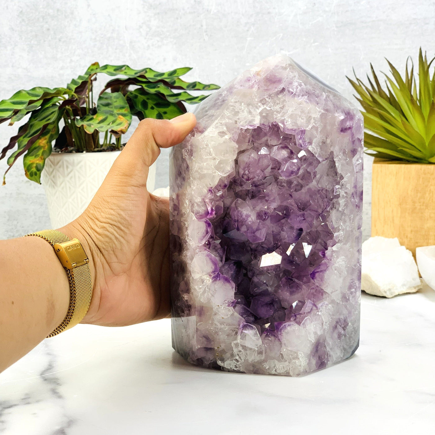 Hand comparing size to the Amethyst Druzy Polished Point
