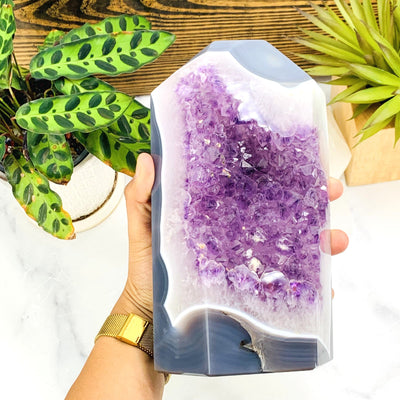 Hand holding the Frontside of the Amethyst Druzy Cut Base